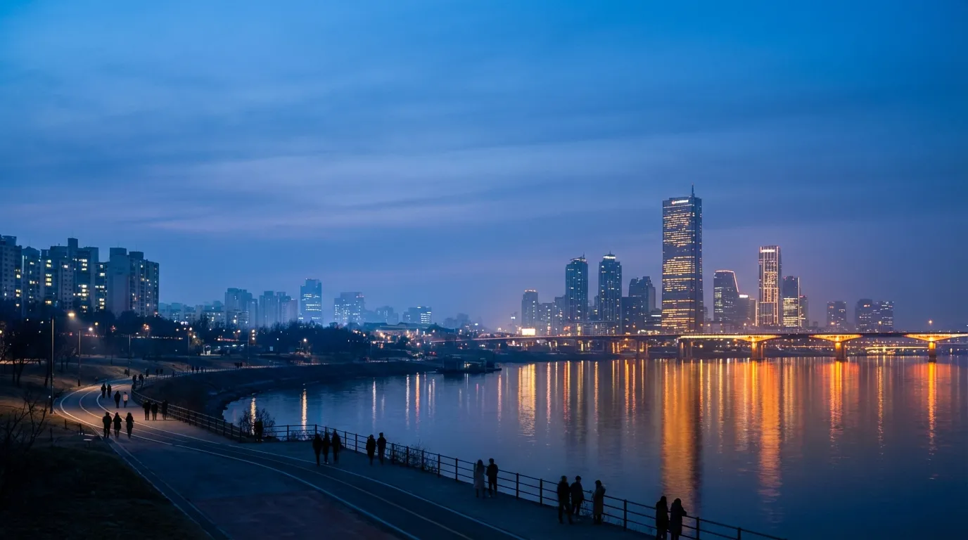 Han River park during blue hour with the Seoul skyline and twilight still visible
